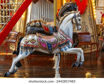 beautiful horses on rotating carousel in the amusement park in the evening - Powered by Shutterstock