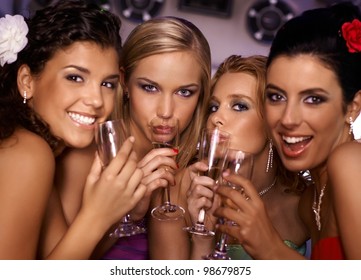 Beautiful hot girls having party fun, drinking champagne.