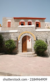 Beautiful House Exterior With Shrubbery On Sunny Day