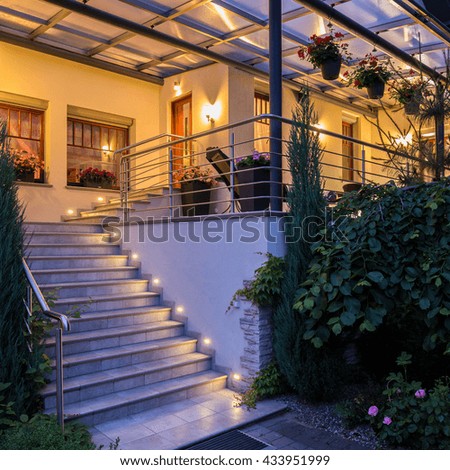 Similar – dark house at night with illuminated windows