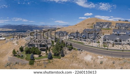 Beautiful houses along roads against blue sky and mountains in Lehi Utah. Aerial landscape of an affluent area known as Silicon Slopes viewed on a sunny day.