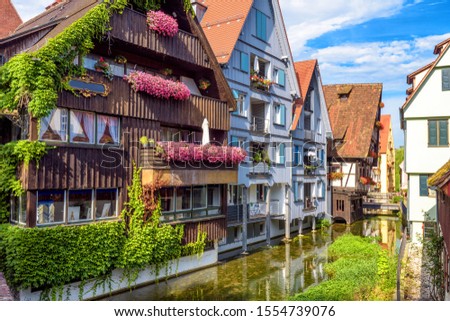 Beautiful houses decorated with flowers in old town of Ulm, Germany. Nice view of historical Fisherman's Quarter, landmark of Ulm. Cozy street of Ulm city with canal. Travel, tourism in Germany theme