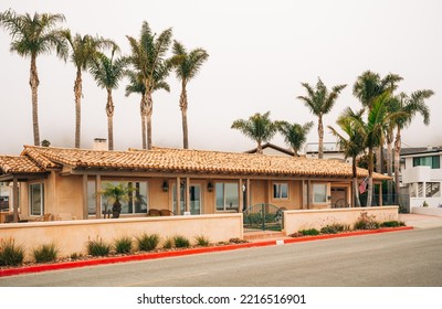 Beautiful Houses With Nicely Landscaped Front The Yard And Clear Blue Sky On Background In A Small Beach Town In California.