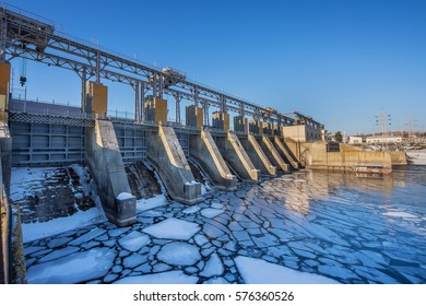 Beautiful Hydro Electric Station  In Winter Against The Blue Sky