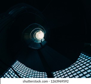 Beautiful and hypnotic spiral convoluted staircase with natural light coming through glass - Powered by Shutterstock