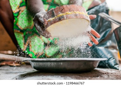 beautiful image of black woman hands searching and sifting corn white flour while cooking traditional african dish with african dress