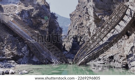 Beautiful image of collapsed bailey bridge in Himachal Pradesh, India. The main focus of the image is on collapsed bridge not hills at back drop. Re submission