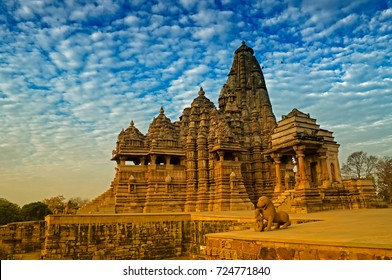 Beautiful image of Kandariya Mahadeva temple, Khajuraho, Madhyapradesh, India with blue sky and fluffy clouds in the background, world famous ancient temples in India, UNESCO world heritage site.