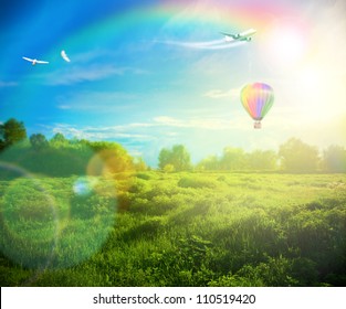 Beautiful image of stunning sunset with atmospheric clouds and sky over vibrant fields in  countryside landscape with hot air balloon, birds and airplane flying high - Powered by Shutterstock