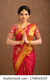 Beautiful Indian bridal greeting in studio shot.