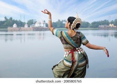 Beautiful Indian classical odissi dancer wears traditional costume posing Mudra or Hand Gestures. Culture and traditions of India. Odissi is a major ancient Indian classical dance