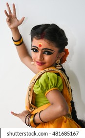 Beautiful Indian girl or women or kid wearing sari or saree traditional dress for females in India Rajasthan. Dressed up as Indian folk/classical dancer posing. wearing ornaments and makeup. 