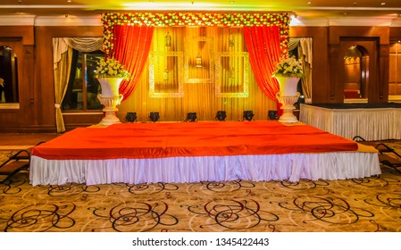 Beautiful Indian wedding ceremony stage set in colors and entrance in red and floral patterns