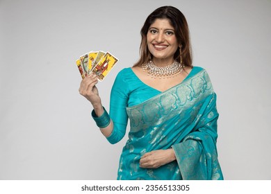 Beautiful Indian woman hands showing Taro Card Reader wearing traditional blue saree isolated on white background. during taro card reader concept theme.