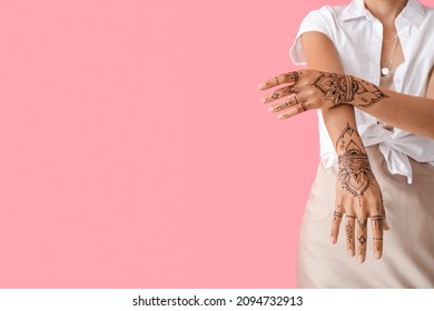 Beautiful Indian woman with henna tattoo on color background - Powered by Shutterstock