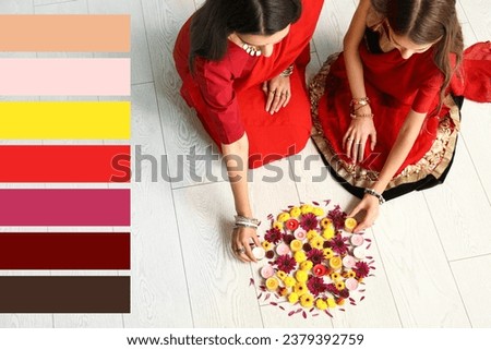 Beautiful Indian woman and her daughter with candles and flowers at home. Different color patterns