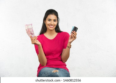 Beautiful Indian Woman Holding Money And Cards Isolated In White Background