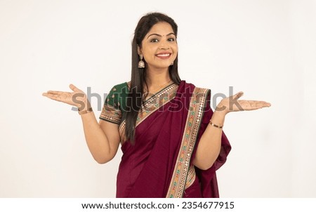 Beautiful Indian woman open hands and looking in front of camera. Celebrating diwali festive of lights, wearing traditional saree prayer isolated on white background. during festival of light 