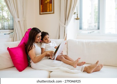 Beautiful Indian Woman Reading A Book To Her Daughter