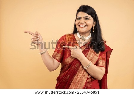 Beautiful Indian Woman Smiling Attractive in wearing trational red color saree showing and facial expressions Copyspace against white background. 