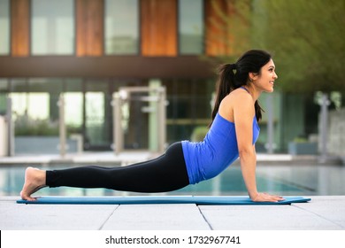 Beautiful Indian Woman Stretching In Plank Upward Dog Pose Outside Her House, Exercising Outdoors, Curvy, Natural, Mixed Race, Practicing Yoga 