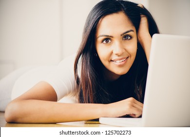 Beautiful Indian Woman Student Using Laptop Computer At Home