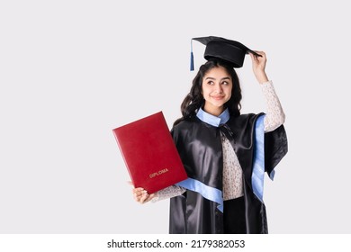 Beautiful indian woman university graduate wearing academic regalia with red diploma mockup isolated on white background.