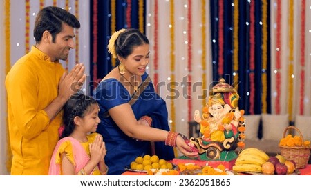 Beautiful Indian woman worshipping Lord Ganesha with pooja ki thali - A festival celebration, small Indian family. Stock video of a smiling female dressed in ethnic saree worshipping Lord Ganpati -...