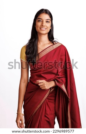 Beautiful Indian young woman in traditional saree in studio shot.