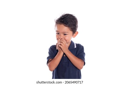 Beautiful Innocent Embarrassed Boy Covering His Mouth, Isolated On White Background. Latin Boy Covering His Mouth While Laughing In Sorrow.