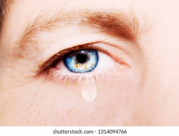 A Beautiful Insightful Look Woman's Eye With Tear Drop. Close Up Shot.