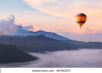 beautiful inspirational landscape with hot air balloon flying in the sky, travel destination - Shutterstock ID 547943572