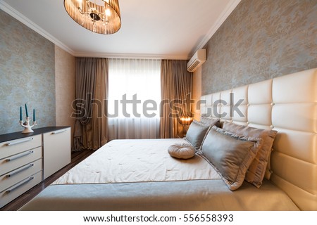 Beautiful interior apartment bedroom. Classic style. Design background. Home decoration. Nature materials. Beige colour. 