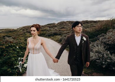 https://image.shutterstock.com/image-photo/beautiful-international-wedding-couple-walks-260nw-1641720523.jpg