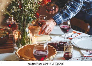 Beautiful, Inviting Thanksgiving Table Set Up With Wine, Pumpkin Pie, Rolls And Candles