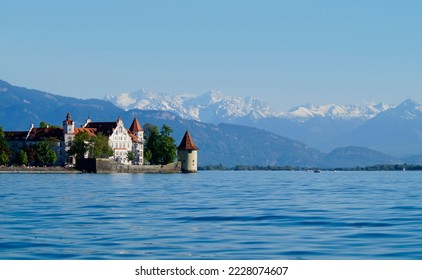 the beautiful island of Lindau on lake Constance (lake Bodensee) with the snowy Swiss Alps in the background, Germany on fine sunny spring day - Shutterstock ID 2228074607