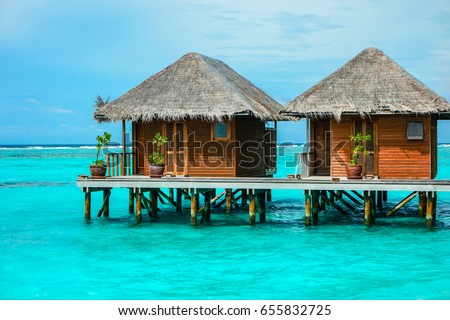 beautiful isolated luxury water bungalows Maldives in the blue green ocean of the maldives