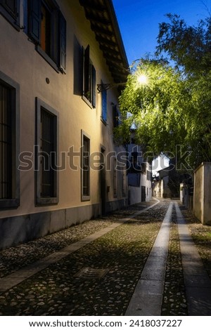 Beautiful Italian alley at dusk. Italian classic urban architecture. Udine city, Friuli Venezia Giulia, Italy.