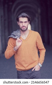 beautiful Italian dark-haired boy with orange jacket and shirt. High quality photo