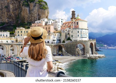Beautiful Italy. Back view of tourist girl exploring amazing Amalfi Coast, Italy.