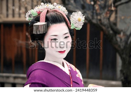Beautiful Japanese Geisha Maiko in Kyoto, Japan with umbrella