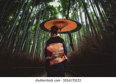 Beautiful Japanese Senior Woman Walking In The Bamboo Forest