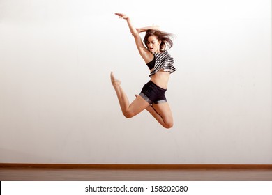 Beautiful Jazz Dancer Jumping During A Dance Rehearsal In A Studio