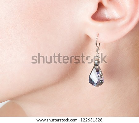 Beautiful  jewellery ear-ring in an ear of young woman