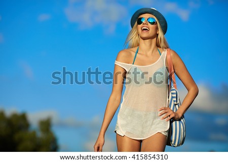 Beautiful joyful blond woman sunbathing at the seaside