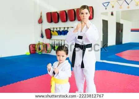 Beautiful karate trainer and girl student practicing martial arts and taekwondo