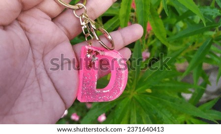 beautiful keychain made of resin in the shape letter D. Epoxy Resin Art. Keychain. 