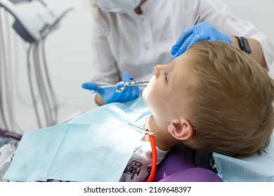 Beautiful Kid Boy In Dentist's Chair The Office Treats Teeth.