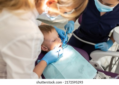 Beautiful Kid Boy In Dentist's Chair The Office Treats Teeth.