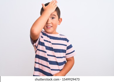 Beautiful Kid Boy Wearing Casual Striped T-shirt Standing Over Isolated White Background Surprised With Hand On Head For Mistake, Remember Error. Forgot, Bad Memory Concept.